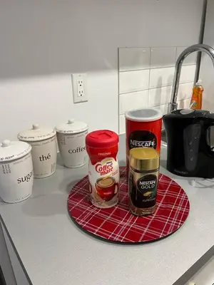 a counter with jars of food on a red rag at Bertha's charming urban retreat in Laval