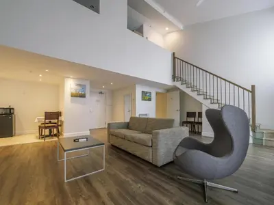 a living room with a couch and a chair at Hotel Lac Brome, BW Signature Collection in Lac-Brome