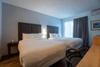 a hotel room with two beds and a window at Hotel Lac Brome, BW Signature Collection in Lac-Brome