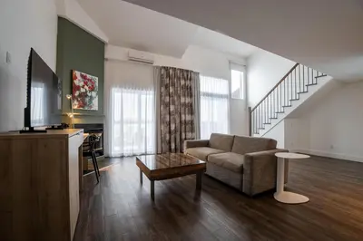 a living room with a couch and a table at Hotel Lac Brome, BW Signature Collection in Lac-Brome