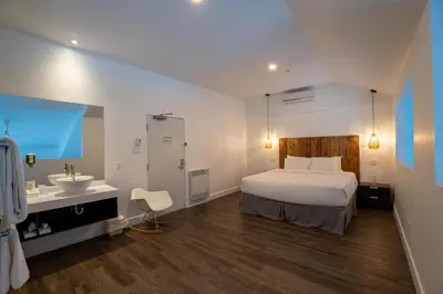 a hotel room with a bed and a sink at Hotel Lac Brome, BW Signature Collection in Lac-Brome