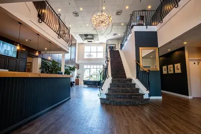 a lobby with a staircase in a building at Hotel Lac Brome, BW Signature Collection in Lac-Brome