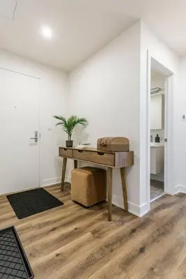 a room with a desk and a potted plant at Executive Class Apartments with Gym for VIP & Students in Downtown MTL in Montréal