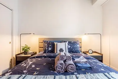 a bedroom with a bed with towels on it at Executive Class Apartments with Gym for VIP & Students in Downtown MTL in Montréal