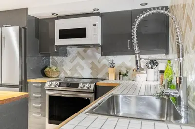 a kitchen with a sink and a microwave at Magnificent 2BR Apartment fully equipped in Montréal