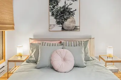 a pink pillow sitting on top of a bed at Magnificent 2BR Apartment fully equipped in Montréal