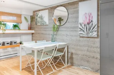 a dining room with a white table and chairs at Magnificent 2BR Apartment fully equipped in Montréal