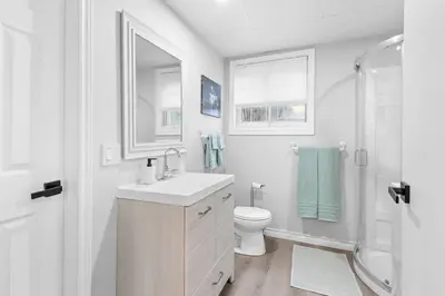 a bathroom with a sink and a toilet and a shower at Spacious Urban Cabin in West Montreal - 4BR in Montréal