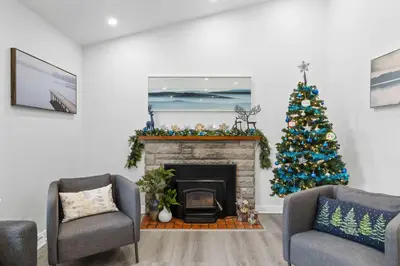 a living room with a christmas tree and a fireplace at Spacious Urban Cabin in West Montreal - 4BR in Montréal