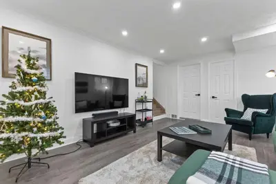 a living room with a christmas tree and a television at Spacious Urban Cabin in West Montreal - 4BR in Montréal