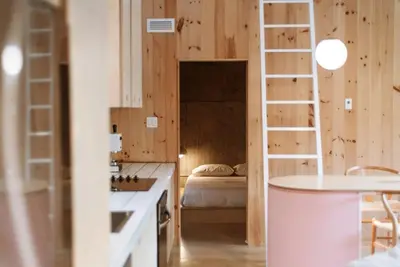 a bedroom with a bed and a ladder in a room at Chez Pedro in Saint-Valère