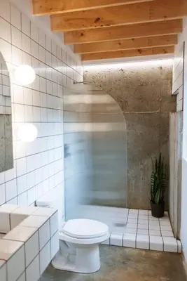 a white bathroom with a toilet and a shower at Chez Pedro in Saint-Valère