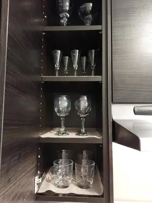 a cupboard with wine glasses on the shelves at Appartement Cartier 2 in Longueuil