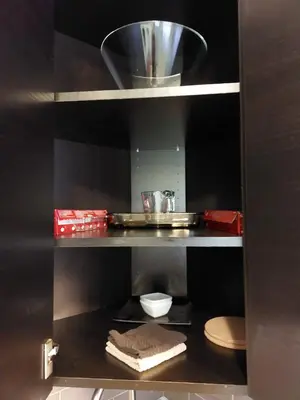 a kitchen with a shelf with a plate and a bowl at Appartement Cartier 2 in Longueuil