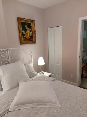 a bedroom with a bed and a picture on the wall at Appartement Cartier in Longueuil