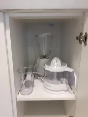 a blender and other appliances on a shelf at Appartement Cartier in Longueuil