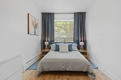 a bedroom with a bed and a window at Large Beautiful 2BR Apartment fully equipped in Montréal