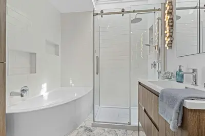 a white bathroom with a tub and a shower at Large Beautiful 2BR Apartment fully equipped in Montréal