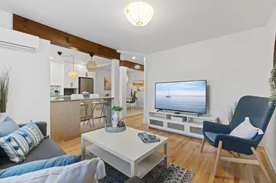 a living room with a couch and a tv at Large Beautiful 2BR Apartment fully equipped in Montréal