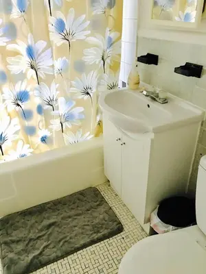a bathroom with a tub and a sink and a toilet at Stylish Montreal Apartment: Comfortable Stay in the Golden Square Mile in Montréal