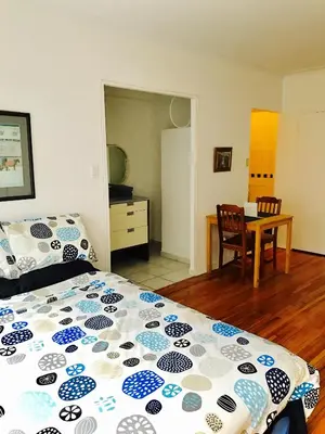 a bedroom with a bed and a dining room at Stylish Montreal Apartment: Comfortable Stay in the Golden Square Mile in Montréal