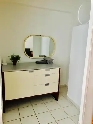 a mirror on top of a dresser in a room at Stylish Montreal Apartment: Comfortable Stay in the Golden Square Mile in Montréal