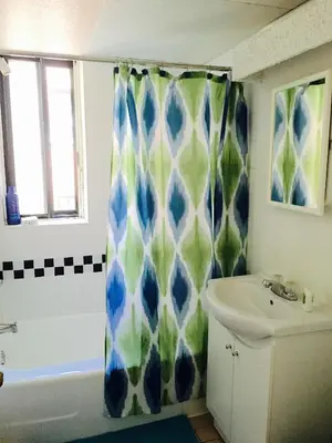 a bathroom with a shower curtain and a sink at Stylish Montreal Apartment: Comfortable Stay in the Golden Square Mile in Montréal