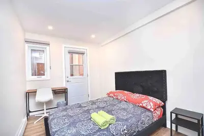 a bedroom with a bed and a desk and a chair at Beautiful 4-BDR in Heart of Plateau Mont-Royal in Montréal