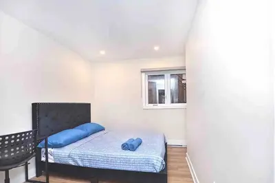 a bedroom with a bed with a blue pillow at Beautiful 4-BDR in Heart of Plateau Mont-Royal in Montréal