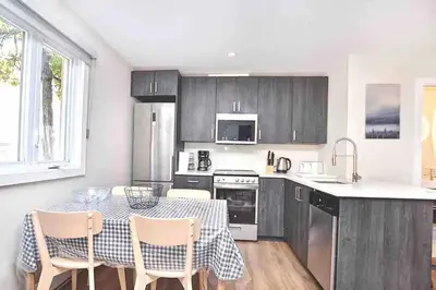 a kitchen with a table and chairs in a kitchen at Beautiful 4-BDR in Heart of Plateau Mont-Royal in Montréal
