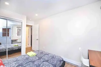 a bedroom with a bed and a mirror at Beautiful 4-BDR in Heart of Plateau Mont-Royal in Montréal