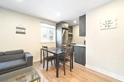 a living room with a table and a couch at DUPLEX 6 BEDROOMS IN HEART OF PLATEAU MONT-ROYAL in Montréal