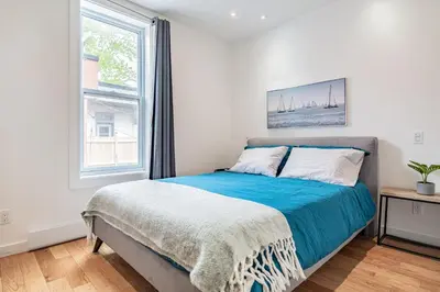 a bedroom with a bed and a window at Ideal Group Stay in Charming Le Plateau Near Metro in Montréal