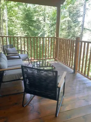 a porch with chairs and a bench on a deck at chalet Ani in Piopolis