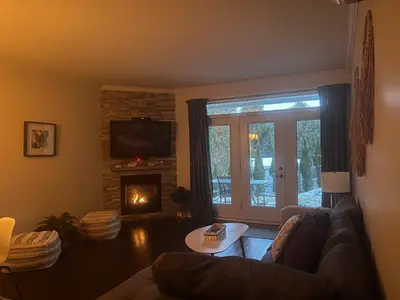 a living room with a couch and a fireplace at Superbe condo - Navette de Ski Gratuite #102 in Bromont