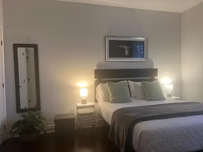 a bedroom with a bed with two lights on at Superbe condo - Navette de Ski Gratuite #102 in Bromont
