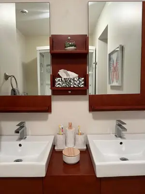 a bathroom with two sinks and a mirror at Superbe condo - Navette de Ski Gratuite #102 in Bromont