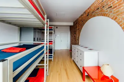 a room with bunk beds and a brick wall at Alt Hostel in Montréal