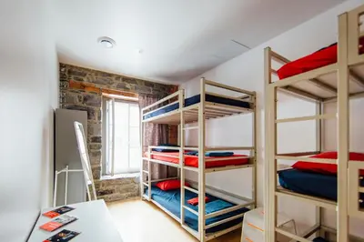 a room with several bunk beds in a room at Alt Hostel in Montréal