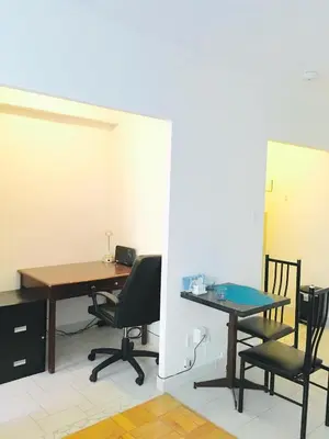 an office with a desk and chairs and a table at Stylish Montreal Apartment: Comfortable Stay in the Golden Square Mile in Montréal