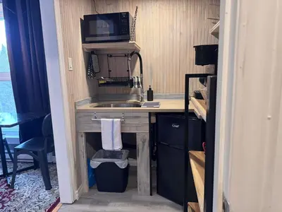 a small kitchen with a sink and a microwave at Le Studio CITQ3O1849 in Saint Pierre de Broughton