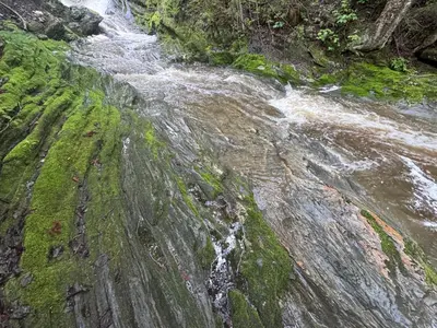 a waterfall on the side of a river at Le Studio CITQ3O1849 in Saint Pierre de Broughton