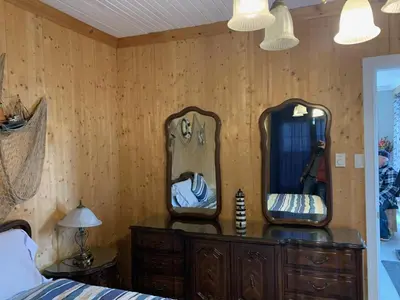 a bedroom with two mirrors on a wooden dresser at Gîte des étoiles in Notre-Dame-Des-Bois
