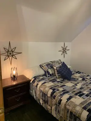 a bedroom with a bed and two stars on the wall at Gîte des étoiles in Notre-Dame-Des-Bois