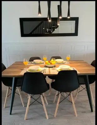a wooden table with chairs and a dining room at Condo Phoenix prés du Lac Memphrémagog. in Magog-Orford