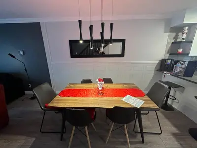 a dining room table with a red table cloth on it at Condo Phoenix prés du Lac Memphrémagog. in Magog-Orford