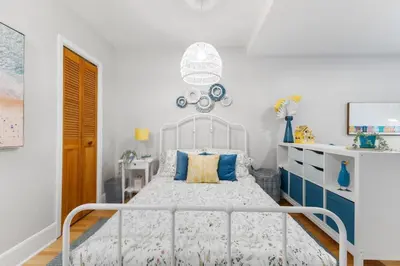 a bedroom with a white bed with blue accents at Charming 1 BR Apartment cozy and fully equipped in Montréal