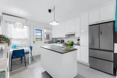 a kitchen with white cabinets and a white counter top at Charming 1 BR Apartment cozy and fully equipped in Montréal