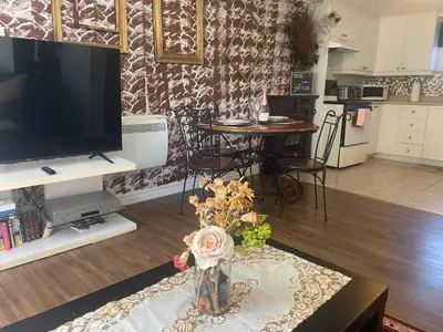 a living room with a vase of flowers on a table at Havre de paix in Laval