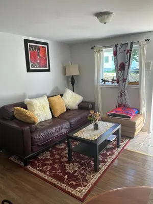 a living room with a brown couch and a coffee table at Havre de paix in Laval